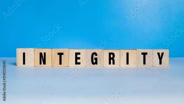 Fototapeta integrity word text on wooden blocks on blue background