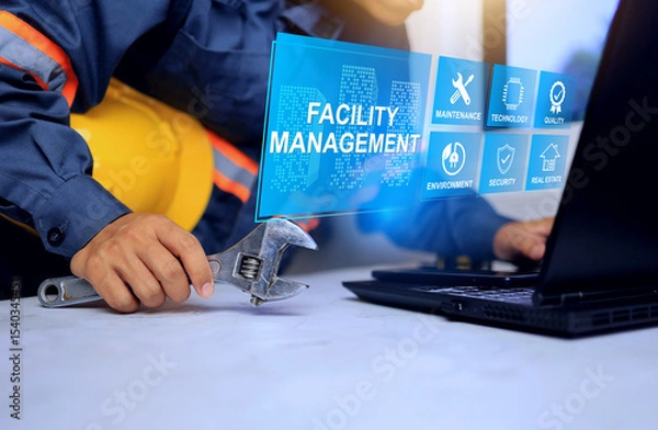 Fototapeta Facility management concept with technician prepare equipment in front of computer screen to ready service and monitoring facility works infrastructure system in smart city and manufacturing plant