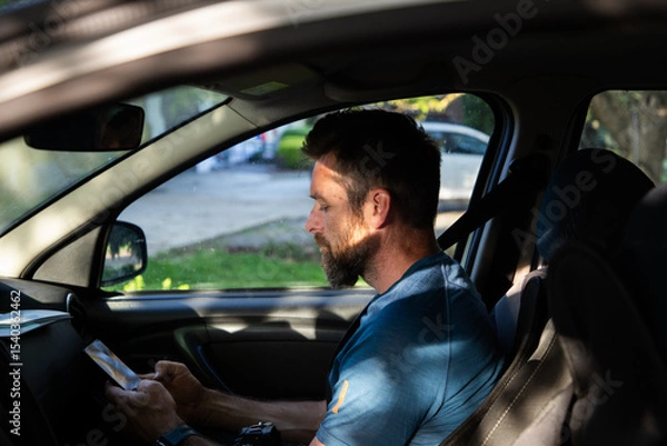 Fototapeta portrait of a man in a car