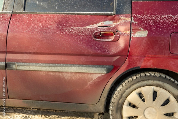 Fototapeta The accident left a trace of significant damage. The rear of the car was damaged, and a dent resulting from the traffic accident was visible.