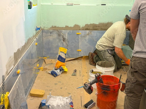 Obraz Renovation Project in Progress With Workers Tiling the Bathroom Area