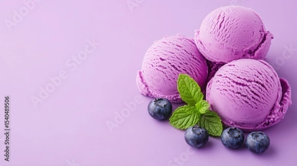 Fototapeta Berry Bliss: An artistic presentation of three scoops of vibrant blueberry ice cream, accompanied by fresh mint leaves and succulent blueberries, offering a refreshing visual treat. 