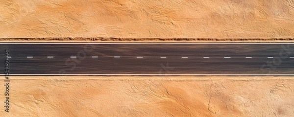 Fototapeta Construction infrastructure highway progress concept. Aerial view of a desert road bordered by textured sand.