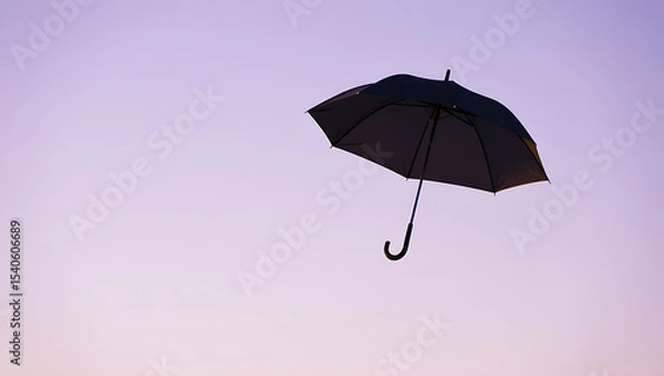 Fototapeta Black umbrella floating in a pastel sky