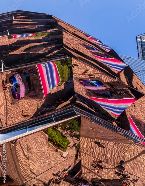 Obraz The Vessel, a unique honeycomb-shaped public landmark at Hudson Yards, reflects back the scene from the sidewalk