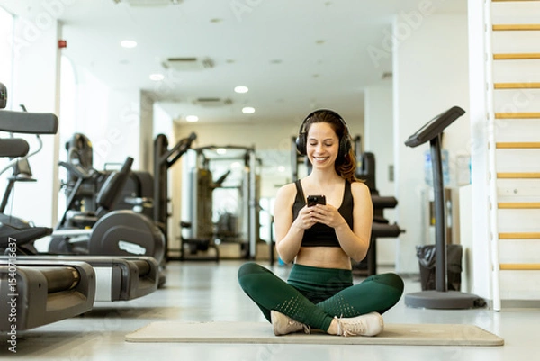 Obraz Engaging in mindfulness through a workout playlist in a modern gym setting