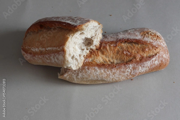 Obraz A broken freshly baked rustic baguette.