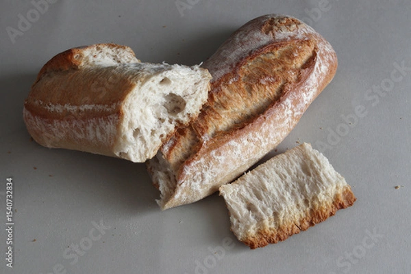 Obraz A broken freshly baked rustic baguette.