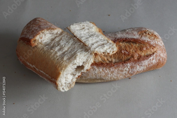 Obraz A broken freshly baked rustic baguette.