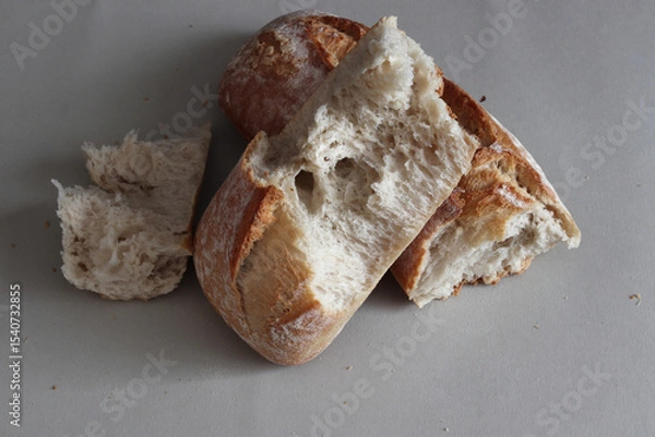 Obraz A broken freshly baked rustic baguette.