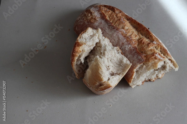 Obraz A broken freshly baked rustic baguette.