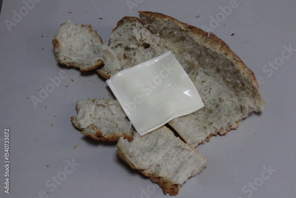 Obraz A broken baked baguette with melted cheese.