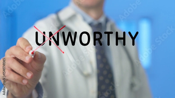 Fototapeta Doctor is crossing out the word unworthy written on a transparent screen with a red marker in a hospital setting, suggesting a concept of worthiness, value, or overcoming negative self perception
