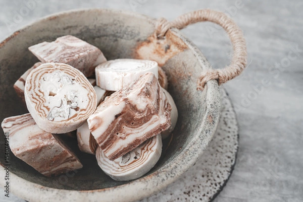 Fototapeta Assortment of halva. Uzbek cuisine. Halva is a sweet confectionery product made from ground sesame seeds or sunflower seeds combined with sugar and nuts. Oriental sweets
