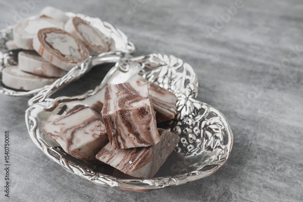 Fototapeta Assortment of halva. Uzbek cuisine. Halva is a sweet confectionery product made from ground sesame seeds or sunflower seeds combined with sugar and nuts. Oriental sweets