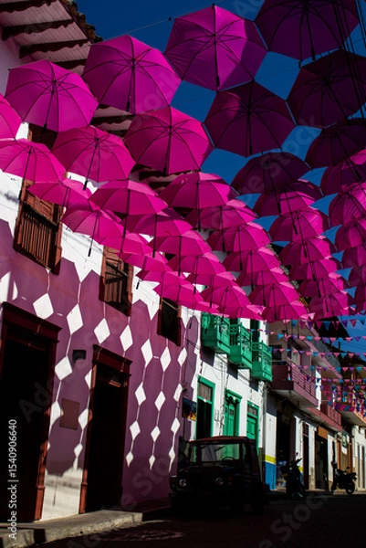 Fototapeta Colorful umbrellas and the beautiful streets of the Heritage Town of Jerico located in the Department of Antioquia in Colombia.