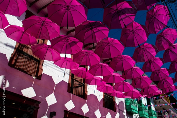 Fototapeta Colorful umbrellas at the beautiful streets of the Heritage Town of Jerico located in the Department of Antioquia in Colombia.