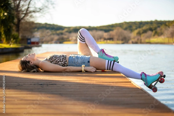Obraz Charming Afternoon by the Lake With Roller Skater Relaxing on a Wooden Dock, Capturing the Essence of Summer Bliss Under a Clear Sky and Gentle Breeze