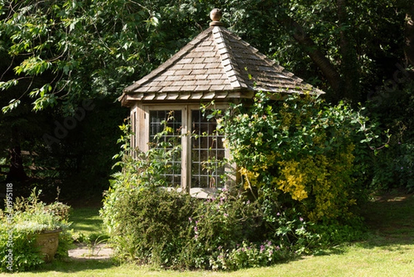 Obraz Cheshire England UK. 01.06.2025. Small summer house in an English country garden.