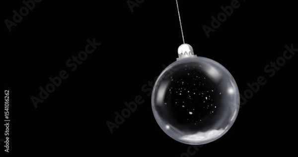 Fototapeta Hanging glass bauble by thin string in studio, with silver cap and white speckles, copy space