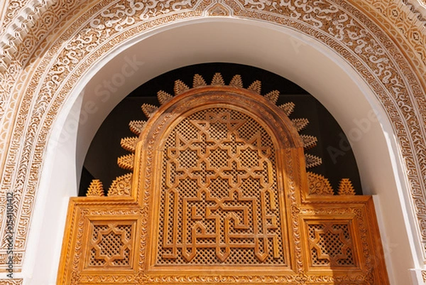 Fototapeta Scenic view of ornate architectural detail in Madrasa Ben Youssef mosque in the Old Town Medina area of Marrakech, west Morocco 