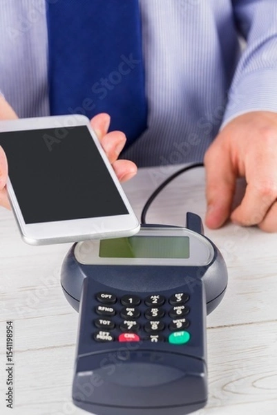 Obraz Man using smartphone to express pay