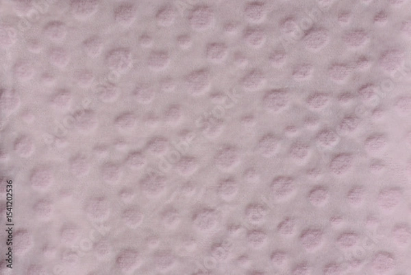 Fototapeta Light pink fabric with textured circular dots close-up abstract background