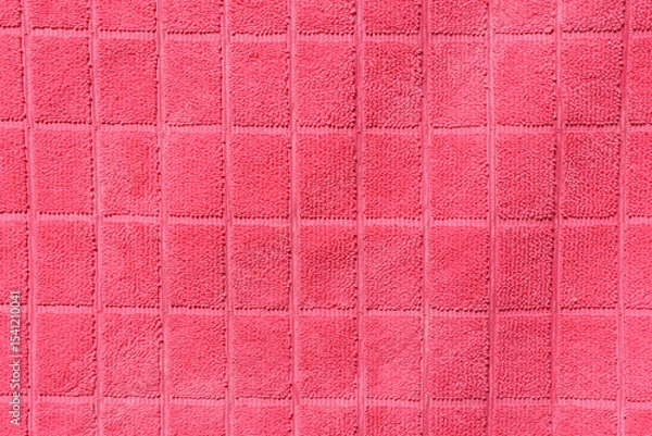 Fototapeta Pink fabric with a grid pattern close-up abstract textured background