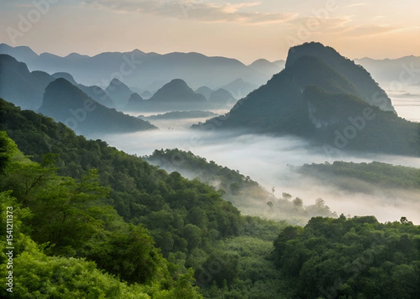 Obraz Misty Mountain Vista: The image depicts a breathtaking view of rolling mountains shrouded in a veil of mist, painted by the soft hues of dawn. An ode to natural serenity.