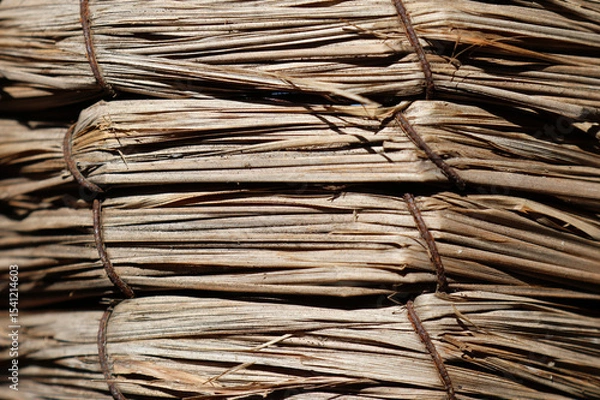 Fototapeta Tightly-bound bundles of dried straw close-up abstract textured background