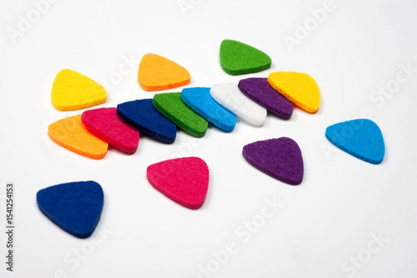 Fototapeta Felt picks in different colors for playing the ukulele or other string instruments.