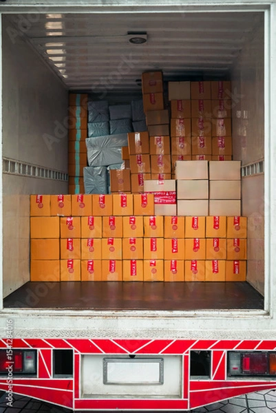 Fototapeta Container vans loaded with parcels ready for transport to various locations. A concept for a growing delivery business following the online shopping business.