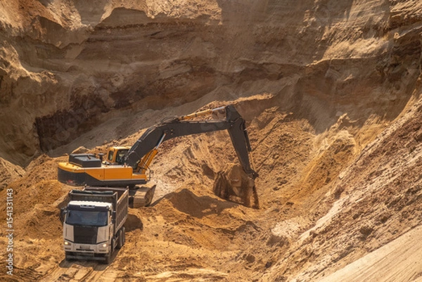 Fototapeta The process of loading sand in a sand quarry. Trucks are waiting for cargo.