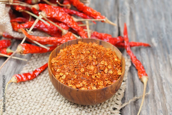Fototapeta Cayenne pepper and dried chilli with sack on wooden table
