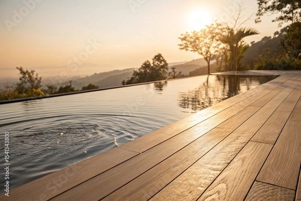 Fototapeta Infinity pool at sunrise with scenic mountain view. Peaceful infinity pool beside wooden deck overlooking mountains and trees at sunrise, ideal for travel, wellness, or resort imagery