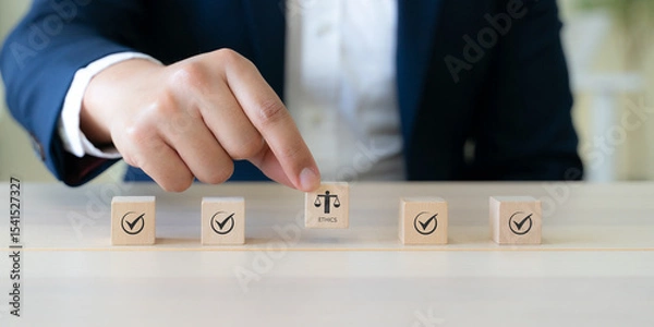 Obraz Ethical Assessment Concept. Placing wooden blocks with icons including checkmarks and a symbol of ethics, representing the evaluation and validation of ethical standards. Effective compliance.