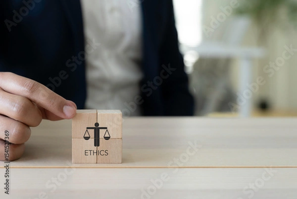 Obraz Business Ethics Concept. A person in business attire placing wooden blocks with an icon representing ethics; corporate responsibility, integrity and moral. The effective compliance and ethics culture.