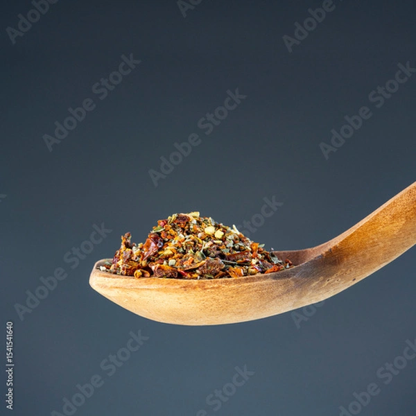 Obraz Aromatic spice mixture piled on rustic wooden utensil, great for gourmet cooking and flavor enhancement themes