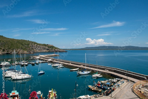 Fototapeta image that captures the charm of Porto Ercole, the sea, with its extraordinary maritime landscape, history and summer atmosphere. Inspiring landscapes rich in visual beauty and culture in Italy