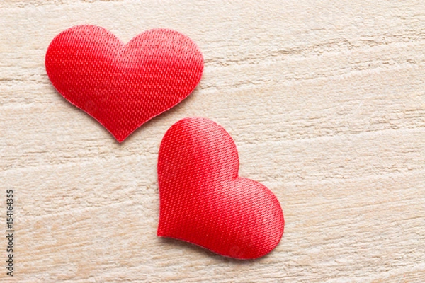 Fototapeta Heart-shaped objects on a wooden background