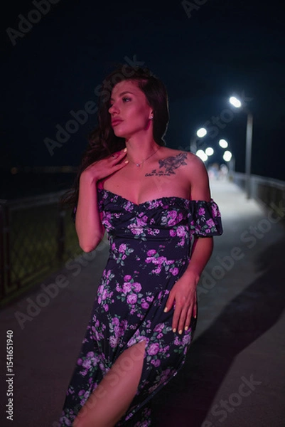 Obraz Woman in red light posing at the night pier