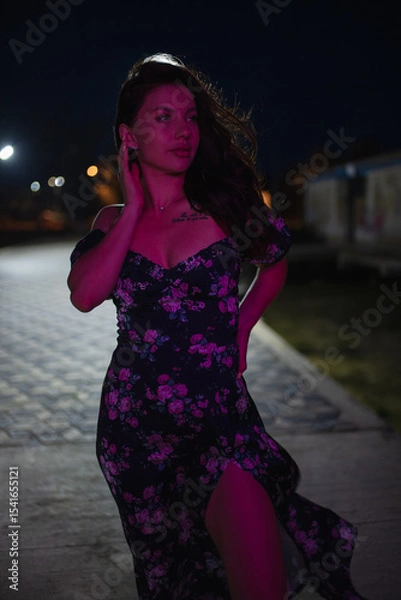 Obraz Woman in red light posing at the night pier