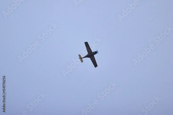 Fototapeta a recreational plane seen from below in the sky