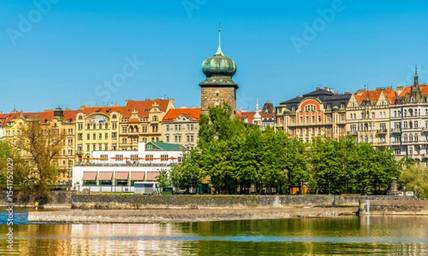 Fototapeta A view from the Vltava river towards the east bank and the Legion Park in Prague in springtime