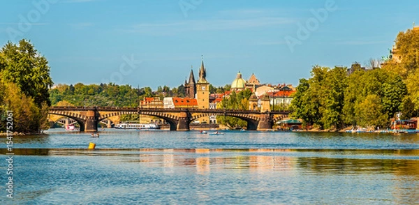 Fototapeta A view from the Vltava river past the Legion Park towards the Legion Bridge in Prague in springtime