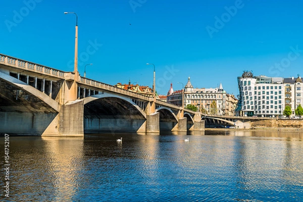 Fototapeta A view from the Vltava river passing under the Jirasek Bridge in Prague in springtime