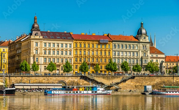Fototapeta A view from the Vltava river towards the east bank after the Jirasek Bridge in Prague in springtime