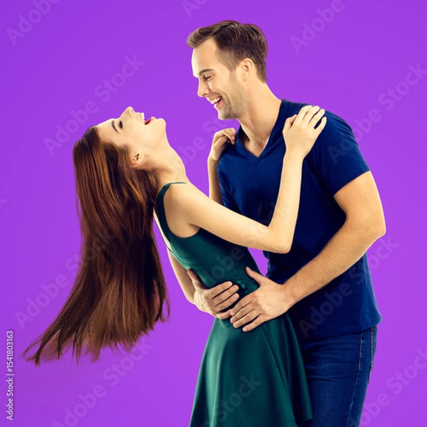 Fototapeta Love, dating, sales concept - hug embracing or dancing expressive emotional very happy couple, looking at each other. Man, woman isolate purple background. Square image
