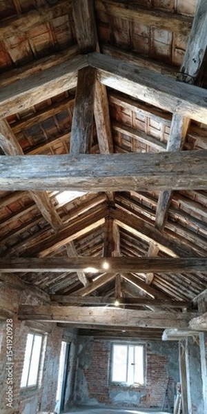 Fototapeta Rustic wooden beams create a charming atmosphere in an unfinished interior space in rural area