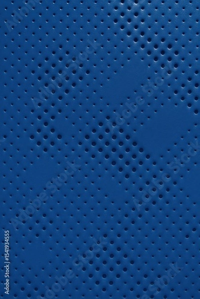 Fototapeta Macro top-down view of a blue synthetic surface with a geometric pattern of circular perforations, forming a gradient density grid across the frame.